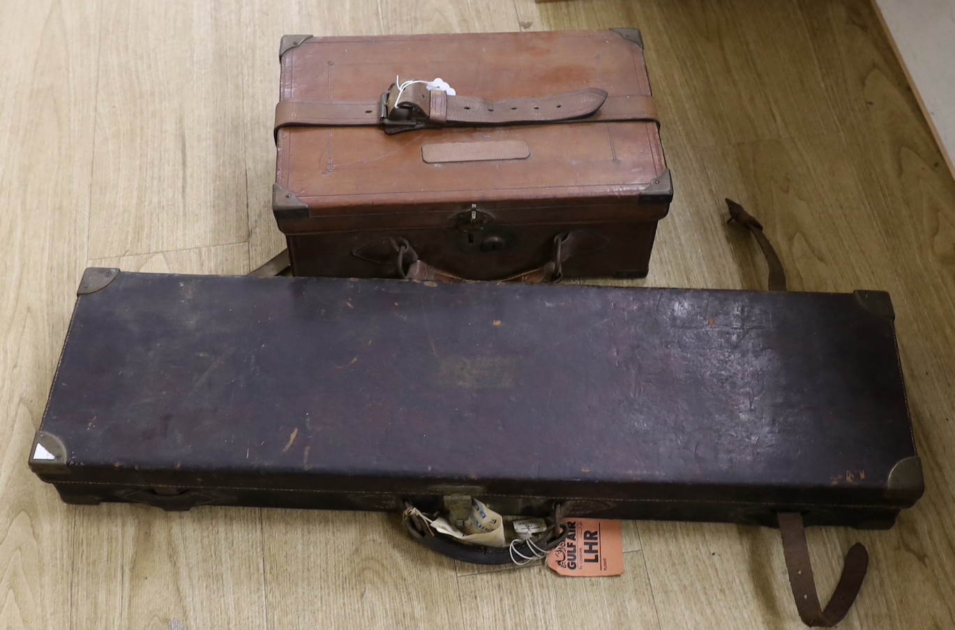 A 19th century leather cartridge magazine and a similar gun case (2)